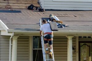 Light-colored residential roof reflecting sunlight above a ventilated attic on a clear summer day.