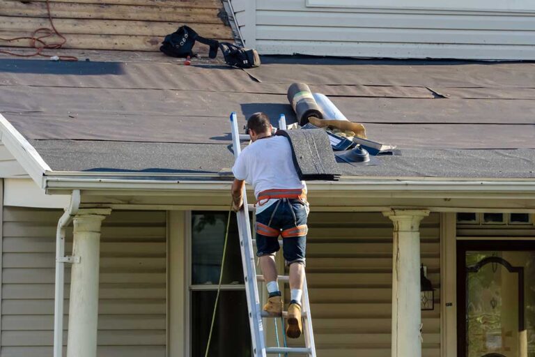Light-colored residential roof reflecting sunlight above a ventilated attic on a clear summer day.